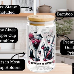 May include: A clear 16oz glass sipper cup tumbler with a bamboo lid. The tumbler features a spooky summer design with skulls, a cocktail, and the text "SUMMERWEENLICIOUS". Includes a free straw and fits in most cup holders.