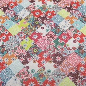 May include: A colorful patchwork fabric with a diamond pattern. The fabric features a variety of floral and geometric designs in shades of red, orange, yellow, green, blue, and brown.