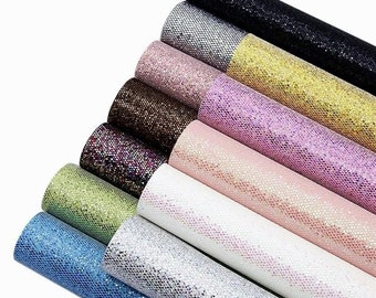 May include: A set of ten rolls of glitter faux leather in various colors, including black, silver, gold, pink, brown, green, blue, and white. The faux leather has a textured, sparkly finish.