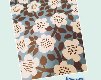 May include: A blue and white floral fabric with brown stems and leaves. The fabric has a repeating pattern of stylized flowers with brown centers.