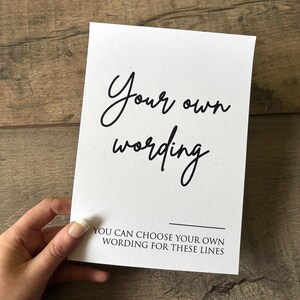 May include: White card with black text that says "Your own wording" and "You can choose your own wording for these lines".