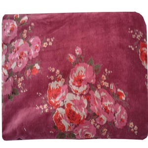 May include: A close-up of a burgundy fabric with a floral pattern. The fabric features pink and red roses with white accents.