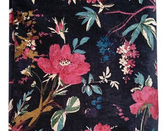May include: Black fabric with a floral pattern in shades of pink, green, and blue. The fabric has a velvet texture.