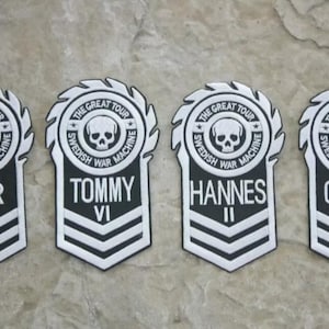 May include: Four black and white embroidered patches with a skull and crossbones logo. The patches have the text "The Great Tour Swedish War Machine" and the names "Pär III", "Tommy VI", "Hannes II", and "Chris VII".