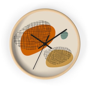 May include: A round, wooden-framed clock with a white face and black hands. The clock face features three abstract shapes in orange, yellow, and blue with a black grid pattern.