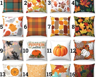 May include: A selection of sixteen decorative cushions with autumnal designs. The cushions display patterns including plaid, leaves, pumpkins, and geometric shapes in orange, brown, green, and white. Some cushions have the text "Pumpkin Patch".