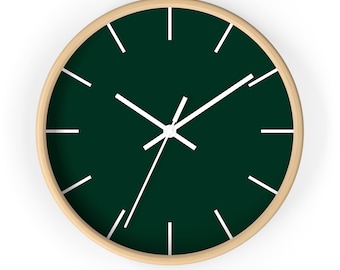 May include: A round, wooden-framed clock with a dark green face and white hour and minute hands. The clock has white markings for the hours.