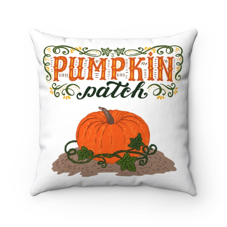 May include: White square pillow with a colorful graphic. The design features an orange pumpkin with green vines and the words "PUMPKIN patch" in orange and green script. The pillow is a fall-themed decorative item.