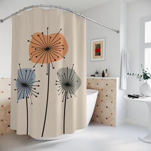 May include: A beige shower curtain featuring a modern floral design. The design includes three stylized flowers with black stems and radiating lines, with orange, blue, and gray accents. The curtain is hanging in a bathroom.