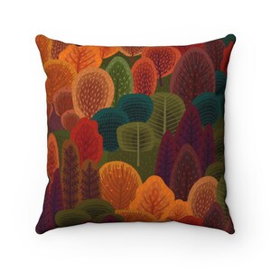 May include: Square throw pillow featuring a colorful forest design. The pillow showcases a variety of stylized trees in shades of orange, red, green, and purple. The design is printed on a square pillow, perfect for adding a touch of nature-inspired decor.