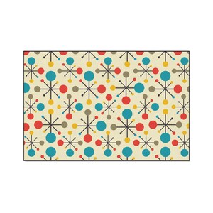 May include: A rectangular rug with a retro atomic starburst pattern. The design features a cream-colored background with repeating starbursts in red, blue, yellow, and gray. The starbursts are connected by thin black lines.