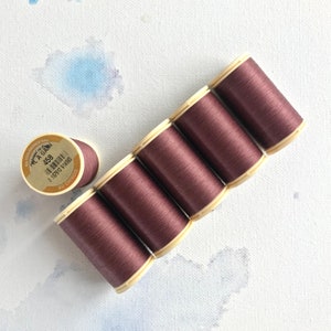 May include: Six spools of brown thread with a label on one spool that reads "C.A. Glass 458 All Cotton 1 87913 91450"