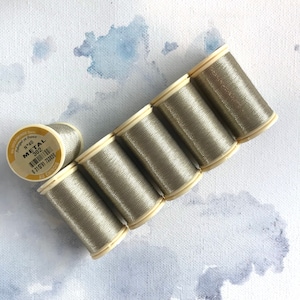 May include: Six spools of metallic gold thread, each with a label that reads "Metal 302" and "Au Chinois".