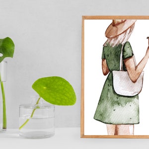 May include: A watercolor illustration of a person wearing a green dress, a brown hat, and a white tote bag. The person is holding a brown and white to-go cup.