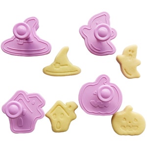 May include: A set of eight pink and yellow Halloween cookie cutters. The cutters are shaped like a ghost, a witch's hat, a pumpkin, a house, and a ghost.