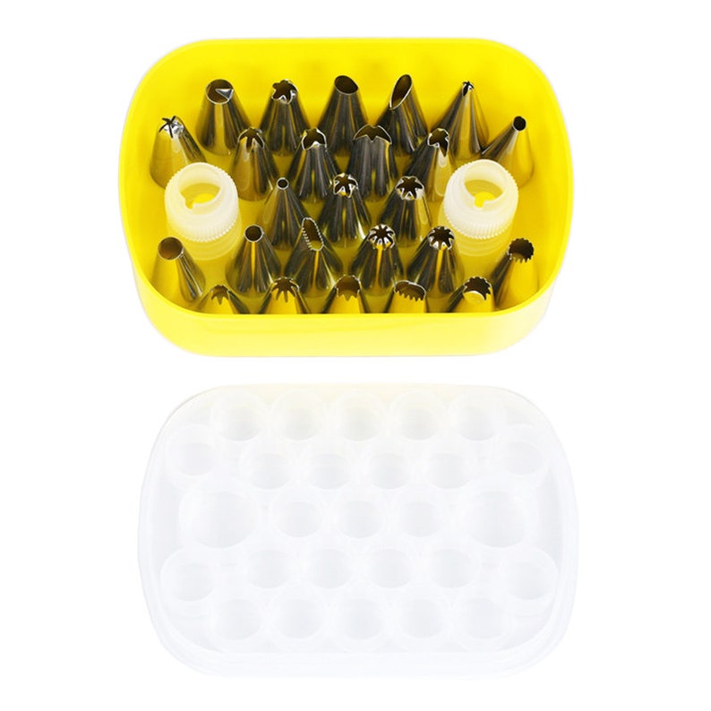 May include: A yellow plastic case with a clear lid containing 24 stainless steel piping tips for decorating cakes and pastries.