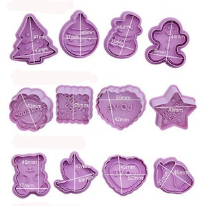 May include: A set of 15 purple plastic cookie cutters in various shapes, including a bunny, a chick, a butterfly, a Christmas tree, an ornament, a snowman, a gingerbread man, a heart, a star, a bear, a bird, a unicorn, a pumpkin, a ghost, and a witch's hat. The cutters are all different sizes and have measurements in millimeters.