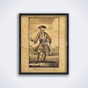 May include: Framed sepia-toned print of Blackbeard the Pirate, holding a sword. The vintage illustration shows a man in a tricorn hat and coat, with a ship in the background. The text "Blackbeard the Pirate" is at the bottom.