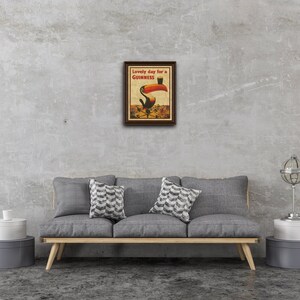 May include: A vintage-style poster advertising Guinness beer. The poster features a toucan holding a glass of Guinness with the text "Lovely day for a GUINNESS".