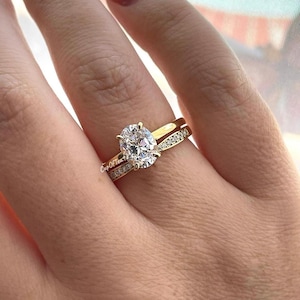 Hidden halo. Yellow gold over sterling silver bridal set with 2CT 6A oval cut CZ Solitare and curved moissanite band