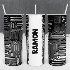 May include: Three black and white stainless steel tumblers with a black and white tool pattern on the sides. The middle tumbler has the name "RAMON" in black text on a white background.