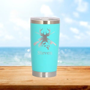May include: A turquoise stainless steel tumbler with a deer and fish graphic and the name "Steven" engraved on the front.