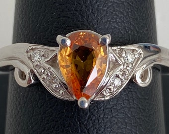 18 Karat White Gold Pear Shape Orange Sapphire and Diamond Band Solitaire Ladies Engagement Ring 0.70 ct