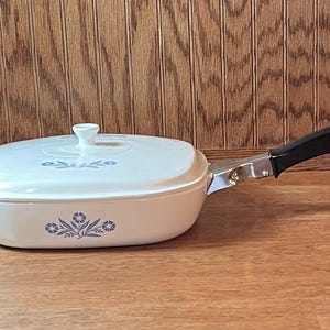 May include: A set of three ceramic mugs with a speckled, matte finish. The mugs are in shades of cream, light gray, and dark gray. Each mug has a simple, minimalist design, perfect for coffee or tea.