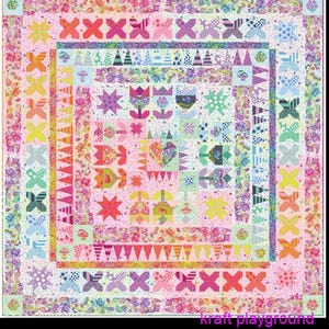 May include: A square quilt featuring a pink background with a repeating pattern of colorful flowers, stars, and geometric shapes. The border displays floral vines and X-shaped motifs in various colors. The text kraft playground appears at the bottom.