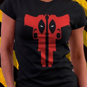 May include: Black t-shirt with a red graphic of two guns with the silhouette of Deadpool's mask in the middle.
