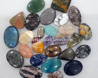 May include: Assortment of 20 natural gemstone cabochons in various shapes, sizes, and colors, including green, blue, brown, red, white, and black. TheNaturalGemstone is printed on the image.