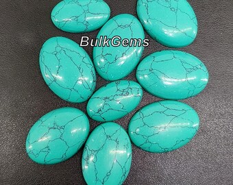 May include: Nine oval-shaped turquoise cabochons with a blue-green colour and black veining. The stones are smooth and polished.