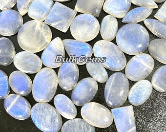 May include: A collection of white moonstone cabochons in various shapes and sizes. The stones have a pearly, iridescent sheen.