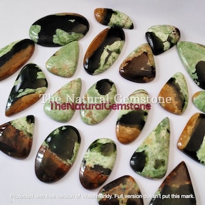 May include: A collection of 16 green, black, and brown gemstone cabochons. The cabochons are various shapes and sizes, including oval, teardrop, and triangular.