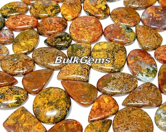 May include: A collection of 25 natural, polished, agate gemstone cabochons in various shapes and sizes. The stones are a mix of brown, yellow, and green colors with intricate patterns. The cabochons are ideal for jewelry making, crafting, and metaphysical uses.