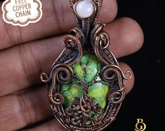 May include: A handcrafted copper wire pendant with a green stone center featuring a tree design. The pendant has a white stone at the top and is intricately woven. The image includes the text "FREE COPPER CHAIN" and the Bulk Gems logo.