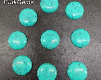 May include: Ten turquoise cabochons, each with a unique marbled pattern, are arranged in a circle on a black surface. The cabochons are smooth and polished, with a light blue hue.