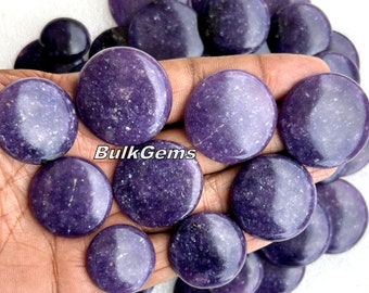 May include: A collection of round, polished, purple lepidolite stones. The stones are smooth and have a sparkly, iridescent finish.