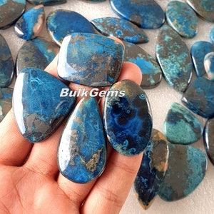 May include: Assortment of blue and grey chrysocolla cabochons in a variety of shapes and sizes. The cabochons are smooth and polished, with a natural, organic look.  BulkGems is printed on the image.