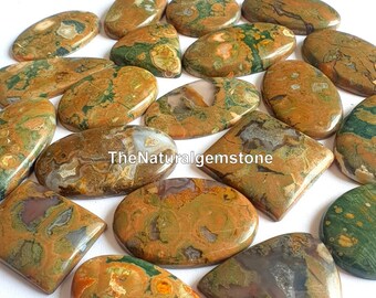 May include: A collection of 15 polished, oval-shaped, and rectangular ocean jasper cabochons. The stones are a mix of brown, green, and white with a variety of patterns and textures. TheNaturalgemstone is printed on one of the stones.