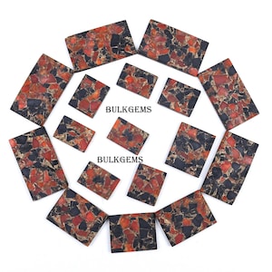 Peut inclure: Plusieurs pierres précieuses rectangulaires et carrées avec un motif de mosaïque. Les pierres présentent un mélange de couleurs rouge, noir et or. Le texte "BULKGEMS" est visible sur certaines pierres.