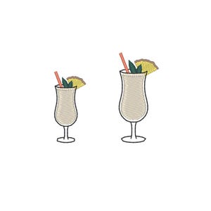 May include: Two embroidered cocktail glasses, likely Pina Coladas, are depicted on a white background. Each glass has a light beige drink, a red straw, a pineapple wedge, and a sprig of mint. The glasses are identical in shape and design.