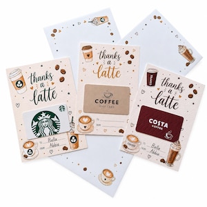 May include: Three cream-coloured gift card holders featuring the text "thanks a latte" in dark script. Each card displays watercolour illustrations of coffee cups and beans. The holders include blank lines for "To" and "From" and feature Starbucks, generic coffee, and Costa Coffee gift cards.