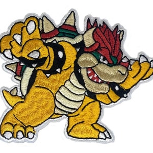May include: Embroidered patch featuring a yellow and red Bowser from the Super Mario Bros. video game series. Bowser is depicted in a menacing pose with his claws extended.
