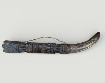 A large African carved wood and horn oliphant