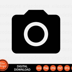May include: Black and white camera icon. The camera icon is a simple silhouette of a camera with a circle for the lens.