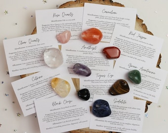 May include: A set of 10 tumbled stones with individual cards describing their properties and meanings. The stones include clear quartz, rose quartz, carnelian, amethyst, red jasper, green aventurine, tiger's eye, black onyx, sodalite, and citrine.