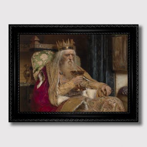 以下が含まれることがあります： 金色の王冠とローブを身につけ、金のゴブレットを持っている老人の額装された絵画。その男性は長い白いひげを生やし、玉座に座っています。絵画は黒いフレームに入っています。