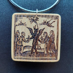 Witches Giving Dolls to the Devil – Occult Pendant with Historical Witchcraft Print – Laser Engraved Northern Oak Amulet