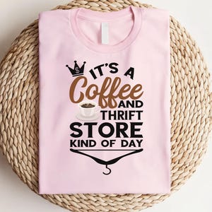 May include: Pink t-shirt with a black and brown graphic that says "It's a Coffee and Thrift Store Kind of Day".